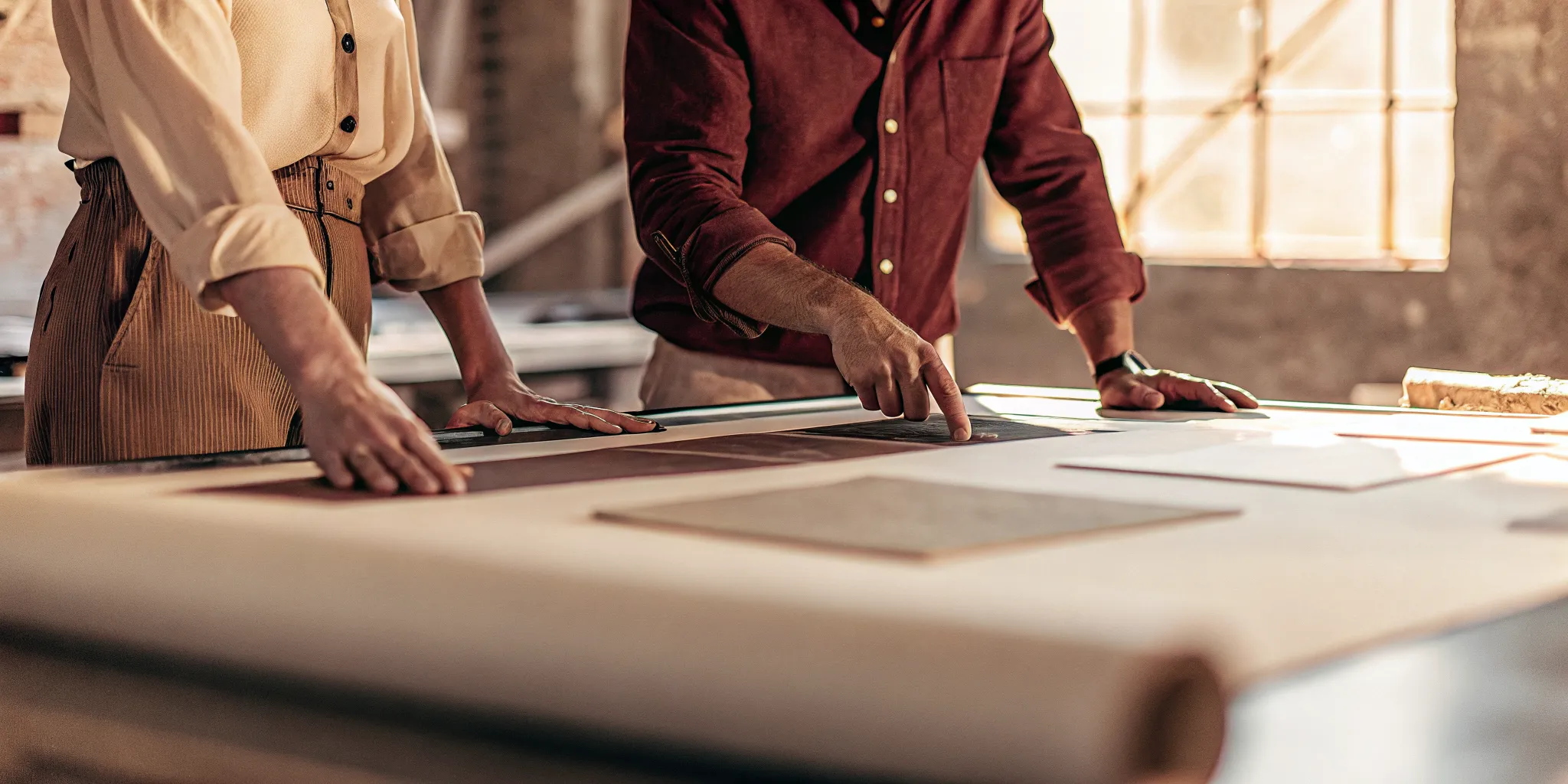Designers at a table reviewing paper samples for a table tent printing project.